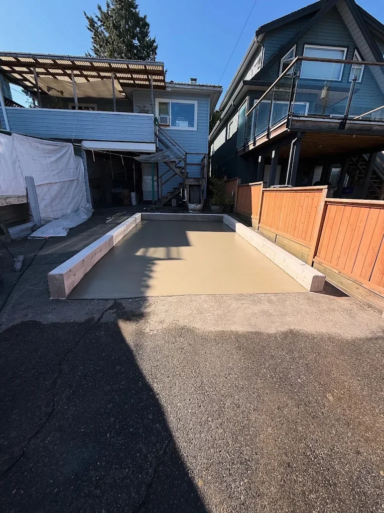 Fresh garage pad poured inside timber forms
